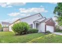 Well-maintained home exterior with vinyl siding, a landscaped yard, and an attached two-car garage at 12604 Buck Run Dr, Noblesville, IN 46060
