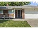 Close-up of a charming brick home featuring a well-kept lawn and a welcoming front entrance at 1346 Carroll White Dr, Indianapolis, IN 46219