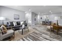 Bright living room featuring hardwood-style floors, modern furniture, and recessed lighting at 1346 Carroll White Dr, Indianapolis, IN 46219