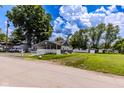 Attractive single-story home with a covered porch, set on a lush green lawn at 1511 E 20Th St, Muncie, IN 47302
