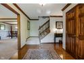 Inviting home foyer with hardwood floors, staircase, and detailed trim at 160 Scranton Ct, Zionsville, IN 46077