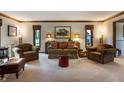 Comfortable living room featuring neutral carpet, sofa, armchairs, and a serene atmosphere at 160 Scranton Ct, Zionsville, IN 46077
