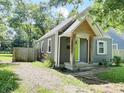Inviting home featuring a gravel driveway and a welcoming green front door at 1601 E 44Th St, Indianapolis, IN 46205