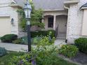 Inviting front porch with detailed brickwork, lovely landscaping, and a charming entrance at 16254 Quartz Dr, Noblesville, IN 46060