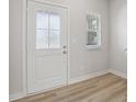 Bright entryway with decorative glass front door, natural wood flooring, and white trim at 1911 Goodwin Pl, Westfield, IN 46074