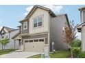 Two-story home with brown and beige siding, an attached two car garage and green grass at 1911 Goodwin Pl, Westfield, IN 46074