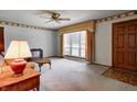 Bright living room with a large window, ceiling fan, and classic finishes at 2020 Rosedale Dr, Indianapolis, IN 46227