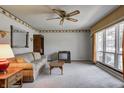 Inviting living room with neutral carpet, ceiling fan, and comfortable furnishings at 2020 Rosedale Dr, Indianapolis, IN 46227