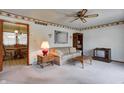 Cozy living room featuring a ceiling fan and vintage decor with access to the dining area at 2020 Rosedale Dr, Indianapolis, IN 46227