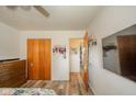 A view of the bedroom featuring a closet, dresser, wood floors, and a mounted TV, providing comfort and functionality at 2113 W Barcelona Dr, Muncie, IN 47304