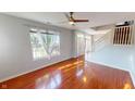 Open-concept living room with gleaming hardwood floors and a staircase at 2259 Colfax Ln # 2259, Indianapolis, IN 46260