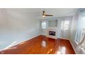 Bright living room featuring hardwood floors, a fireplace, and large windows at 2259 Colfax Ln # 2259, Indianapolis, IN 46260