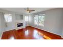 Cozy living room showcasing hardwood floors, a fireplace, and modern ceiling fan at 2259 Colfax Ln # 2259, Indianapolis, IN 46260