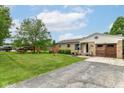 Charming brick home with well-maintained lawn, mature landscaping, and inviting curb appeal at 26858 State Road 19, Arcadia, IN 46030