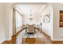 Elegant dining room featuring hardwood floors, chandelier, and natural light at 2783 W High Grove Cir, Zionsville, IN 46077