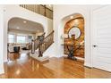 Spacious foyer with wood floors, stairway, and decorative mirror in a custom alcove at 2783 W High Grove Cir, Zionsville, IN 46077