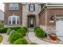 Charming front entrance to home framed by manicured greenery and stone archway at 2783 W High Grove Cir, Zionsville, IN 46077