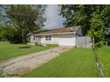 View of the side of the home with an attached garage and concrete driveway at 2807 Carla Ct, Indianapolis, IN 46219