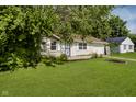 Front exterior with well-maintained lawn and mature trees at 2807 Carla Ct, Indianapolis, IN 46219