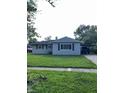 Cozy single-story home featuring a neat front yard and a covered carport at 2826 Falcon Dr, Indianapolis, IN 46222