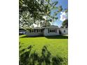 Well-maintained home with lush green lawn and side carport, offering ample space at 2826 Falcon Dr, Indianapolis, IN 46222