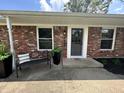 Inviting front entrance with a decorative wreath and a cozy seating bench at 2845 12Th St, Columbus, IN 47201
