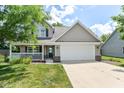 Charming two-story home with a welcoming front porch and attached two-car garage at 3067 Stilton Dr, Cicero, IN 46034
