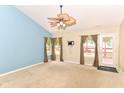 Bright living room features a ceiling fan and glass door to the backyard at 3067 Stilton Dr, Cicero, IN 46034