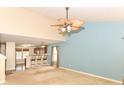 Open-concept living room with a ceiling fan, a view into the kitchen and lots of natural light at 3067 Stilton Dr, Cicero, IN 46034