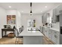 Modern kitchen with white countertops, gray cabinets, and stainless steel appliances at 35 N Keystone Ave, Indianapolis, IN 46201