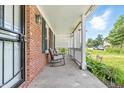 Inviting front porch showcasing brick siding, rocking chairs, and verdant landscaping at 4223 Kestrel Ct, Indianapolis, IN 46254