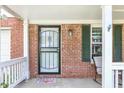 Charming front porch featuring brick siding, black shutters, and a decorative welcome mat at 4223 Kestrel Ct, Indianapolis, IN 46254