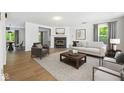 Bright living room features a fireplace, modern decor, and ample natural light at 4223 Kestrel Ct, Indianapolis, IN 46254