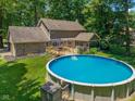 A large backyard with an above ground pool, deck, and mature trees at 429 Glenbrook Ln, Avon, IN 46123