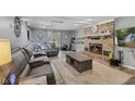 Inviting living room featuring a brick fireplace, plush seating, and natural light at 429 Glenbrook Ln, Avon, IN 46123