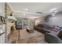Spacious living room featuring a brick fireplace, comfortable seating, and sliding glass doors at 429 Glenbrook Ln, Avon, IN 46123