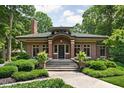 Charming brick home with a green tile roof, manicured front yard, and inviting entrance at 4455 Broadway St, Indianapolis, IN 46205
