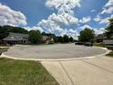 Neighborhood street showcasing various well-maintained homes under a vibrant blue sky with scattered clouds at 4655 Rockcress Ct, Zionsville, IN 46077