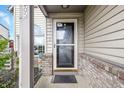 Covered front porch with brick accents, offering a welcoming entrance to the home at 5305 Traditions Rd, Indianapolis, IN 46235