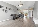 Bright living room boasts hardwood floors, modern lighting, and an open concept layout at 5305 Traditions Rd, Indianapolis, IN 46235