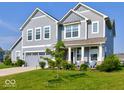 Beautiful two-story home featuring light-blue siding, a two-car garage, and a lush green lawn at 5527 Mahogany Dr, Noblesville, IN 46062