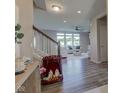 Inviting entryway showcases wood-look flooring, staircase, and glimpses of the living room beyond at 5527 Mahogany Dr, Noblesville, IN 46062