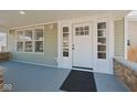Inviting front porch featuring a stylish front door with sidelights at 555 N Oakland Ave, Indianapolis, IN 46201
