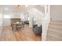 Bright living room featuring hardwood floors, a fireplace, and a staircase at 555 N Oakland Ave, Indianapolis, IN 46201
