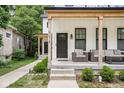 Inviting covered porch featuring comfortable seating and stylish outdoor decor at 5678 N College Ave, Indianapolis, IN 46220