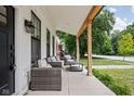 Relaxing outdoor seating area on a covered porch with modern furnishings at 5678 N College Ave, Indianapolis, IN 46220