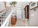 Bright foyer featuring hardwood floors, staircase, and a view of the front door at 5832 Buskirk Dr, Indianapolis, IN 46216
