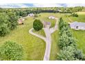 Aerial view of a home on a spacious lot with mature trees and an outbuilding at 7304 E Stop 11 Rd, Indianapolis, IN 46259