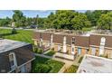 Overhead view of townhomes showing manicured lawns and mature trees at 7468 Countrybrook Dr, Indianapolis, IN 46260