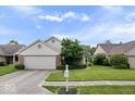 Traditional single-Gathering home featuring a large front yard with healthy green grass and mature landscaping at 8213 Thoroughbred Run, Indianapolis, IN 46256